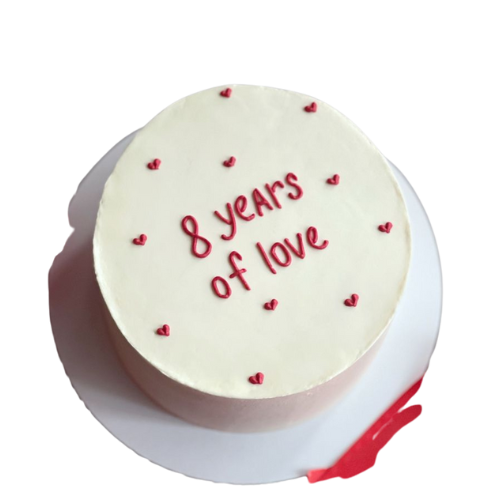 8 years anniversary cake with white icing, red hearts, and love message.