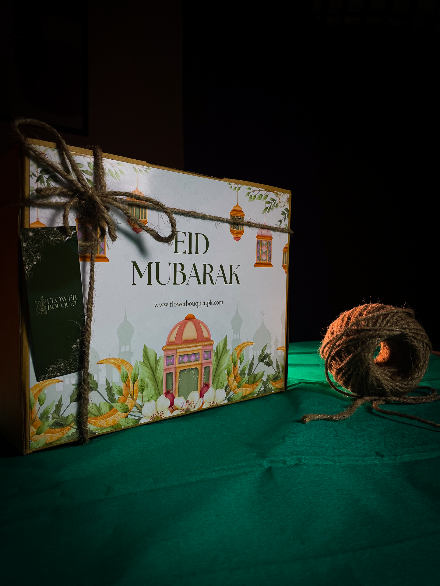 Beautifully arranged Eid Mubarak Gift Box containing greeting cards, chocolates, bangles, photo prints, and jhumkay.