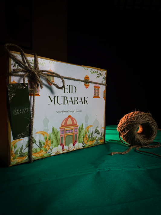 Beautifully arranged Eid Mubarak Gift Box containing greeting cards, chocolates, bangles, photo prints, and jhumkay.