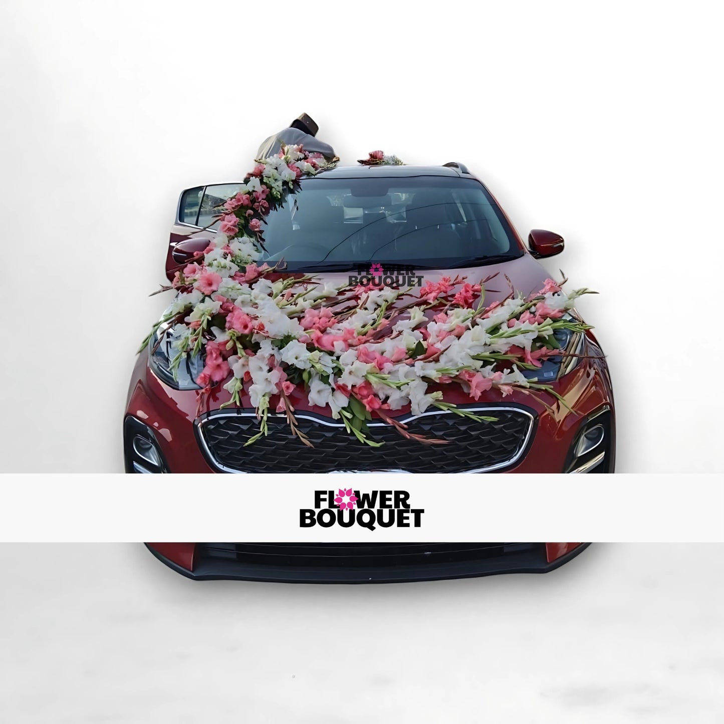 Red car decorated with pink and white flowers on the hood, windshield, and roof.