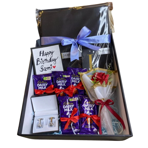 Elegant birthday gift box with unstitched suit, chocolates, cufflinks, and rose bouquet