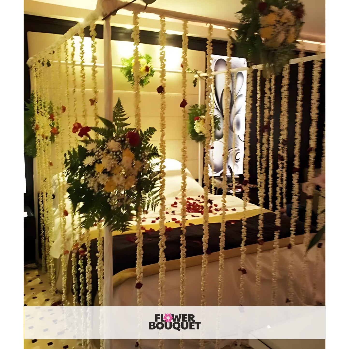 Enchanted Floral Canopy Bed Decor with strings of white flowers, bouquets on the canopy frame, and rose petals on the bed.