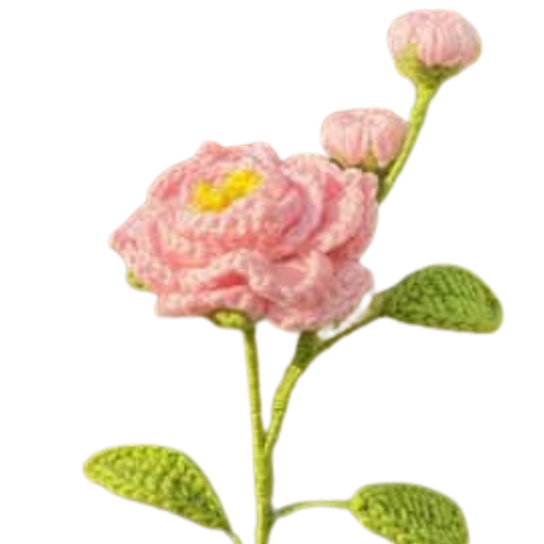 Handmade crochet camellia flower with two pink buds and green leaves on a long stem.