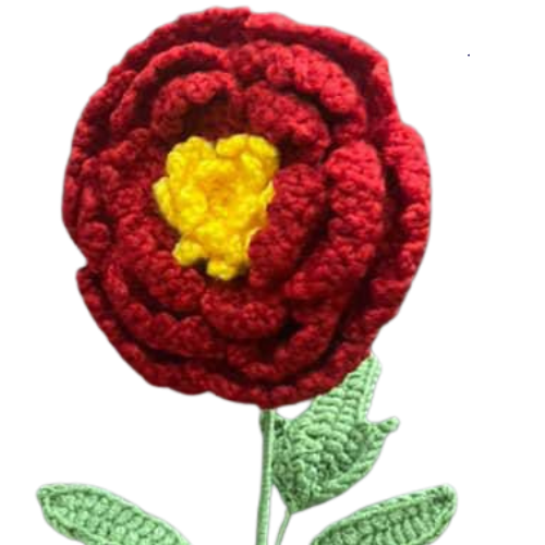 Handmade crochet marigold-inspired flower with red petals, yellow center, and green leaves.