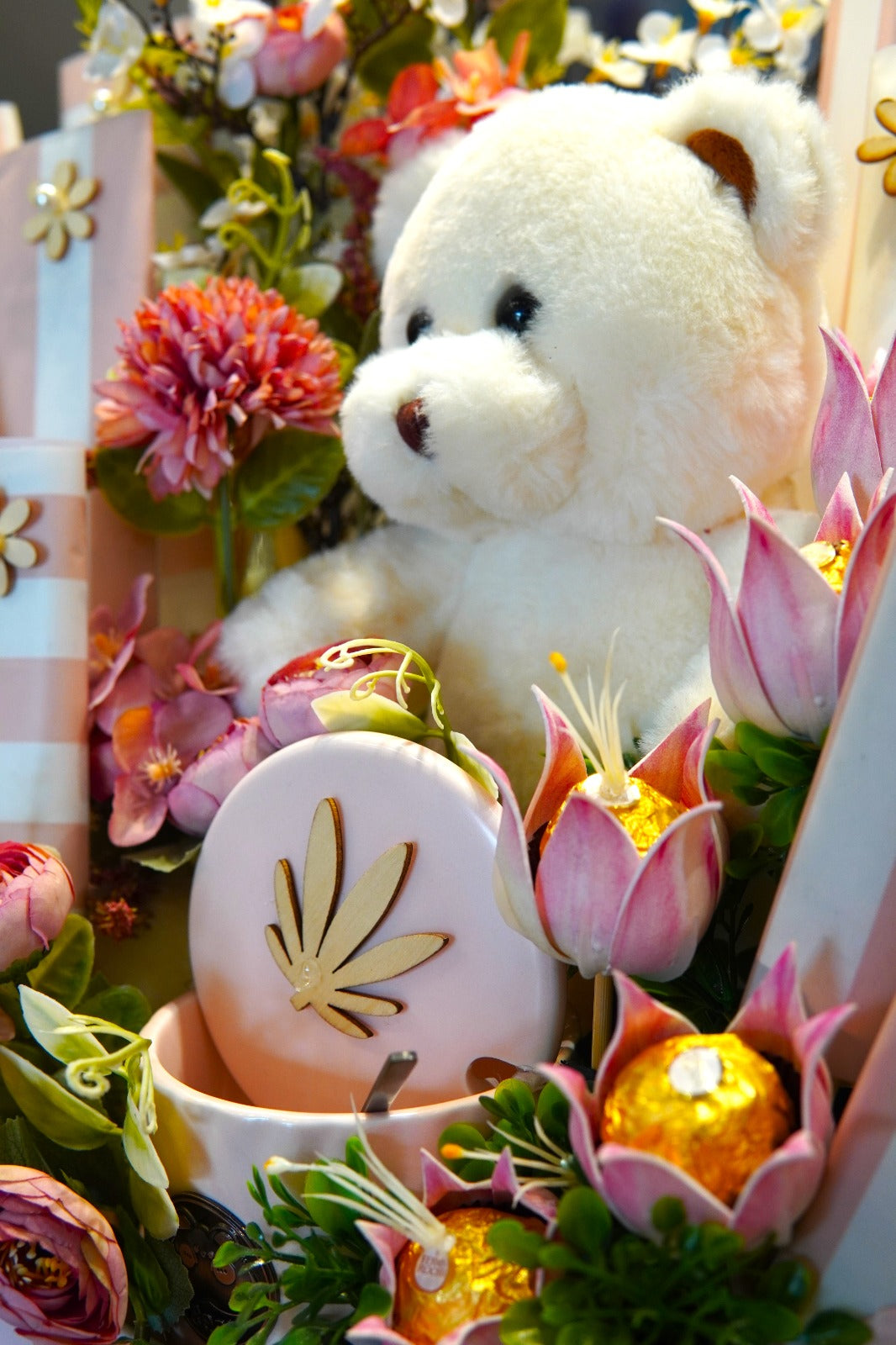 Pink gift box with fresh ranunculus flowers and a soft teddy bear – perfect for baby showers and gift delivery across Pakistan