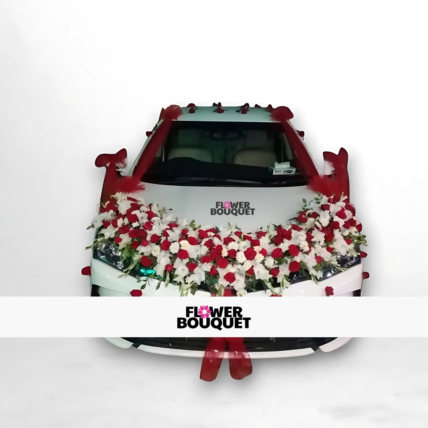 White car decorated with red and white flowers and red fabric.