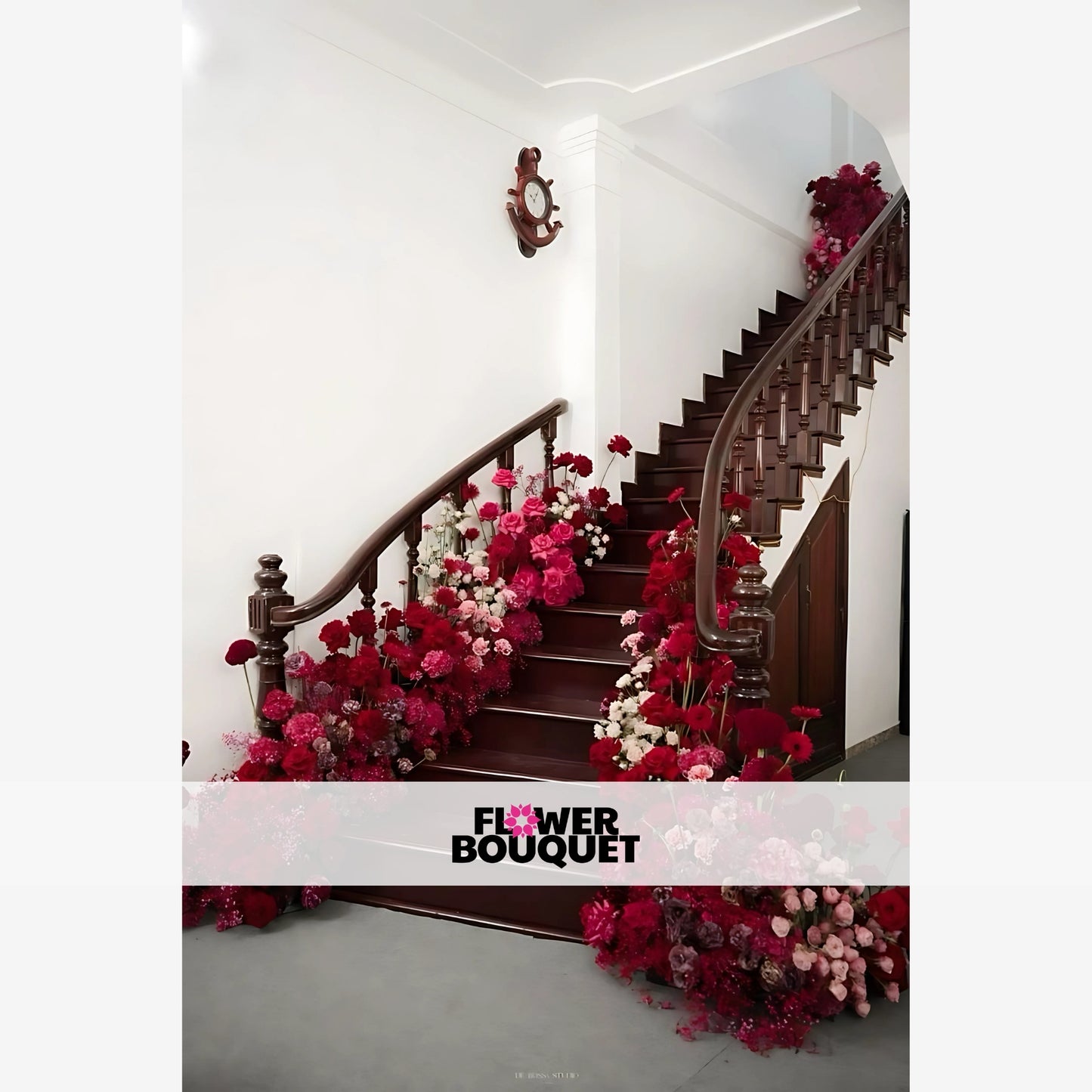 Elegant floral arrangement featuring cascading red, pink, and white blooms decorating a wooden staircase, perfect for weddings and luxury events.