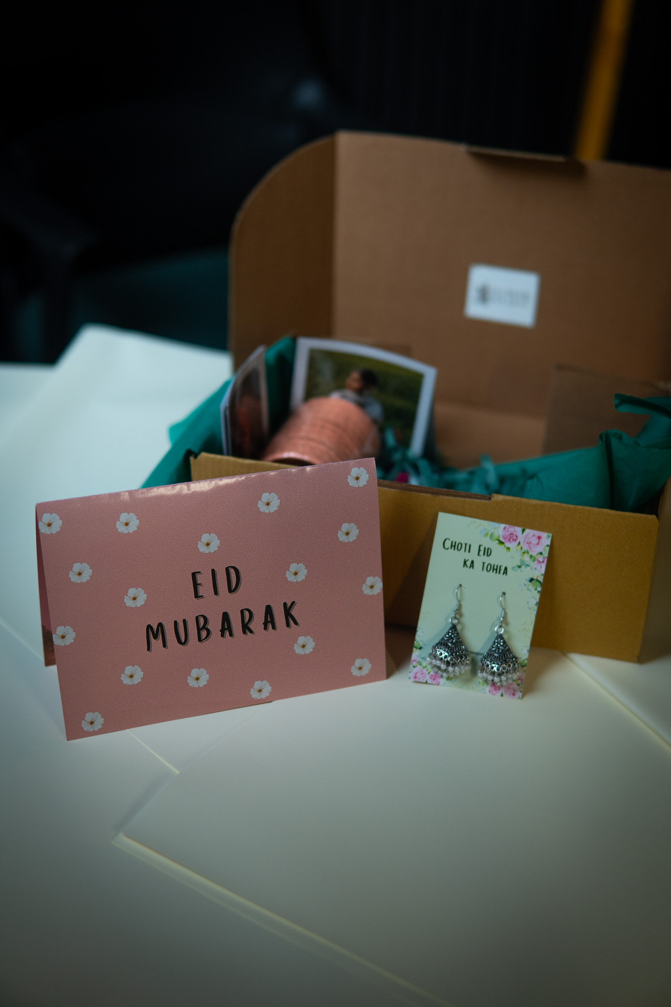 Set of festive Eid cards with intricate designs.with Pair of traditional jhumkay (earrings) included in the Eid gift box.