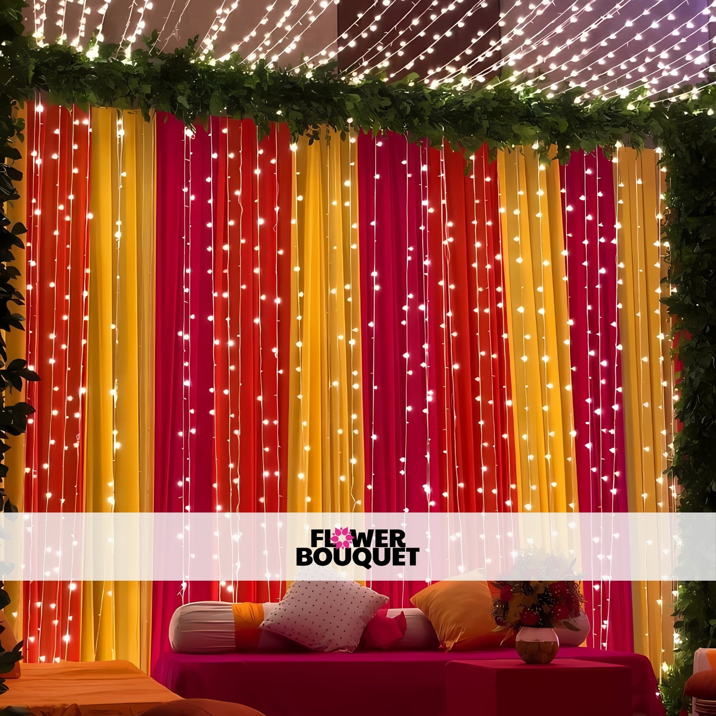 Mehndi decor with red, yellow, and pink drapes, fairy lights, and lush greenery, creating a vibrant and festive backdrop for celebrations.