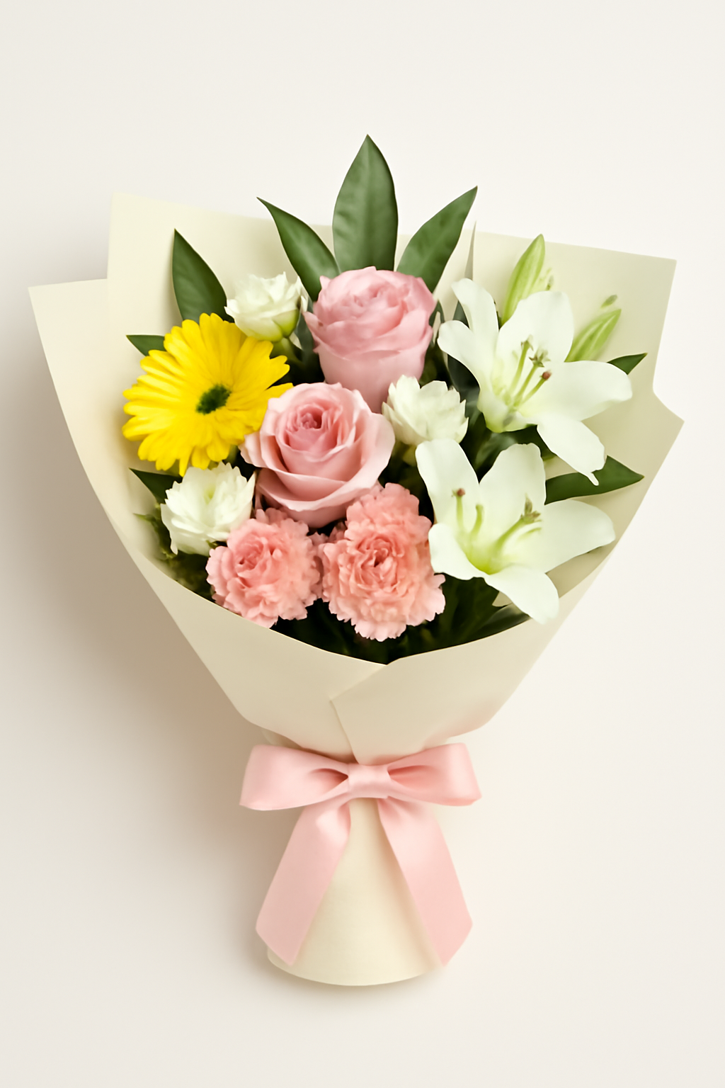 A high-resolution bouquet featuring pink roses, white lilies, yellow gerbera daisies, and carnations, wrapped in cream paper with a pink satin ribbon — perfect for gifting.