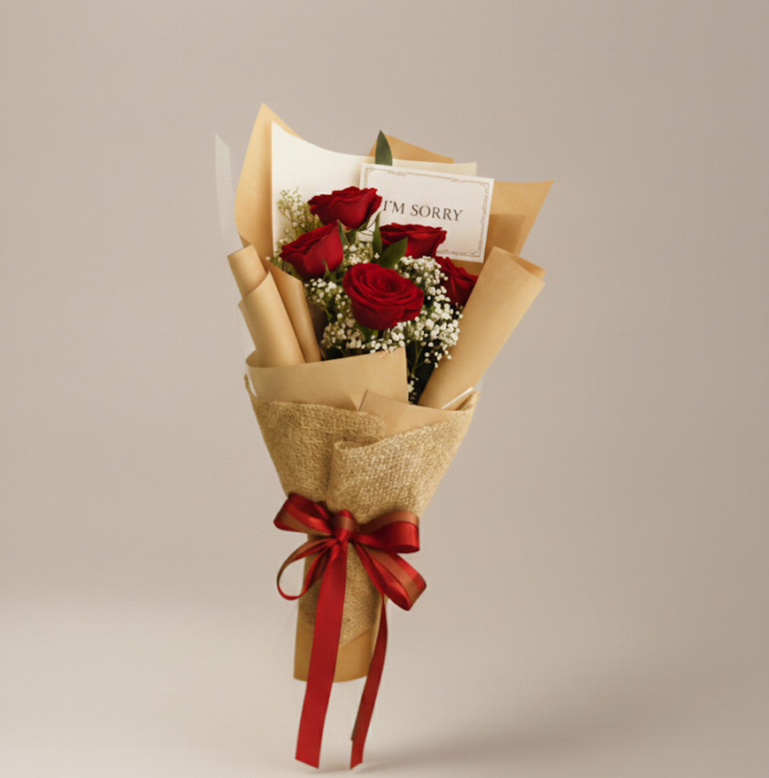 white roses sorry flower bouquet with apology card in it with black wrapping.