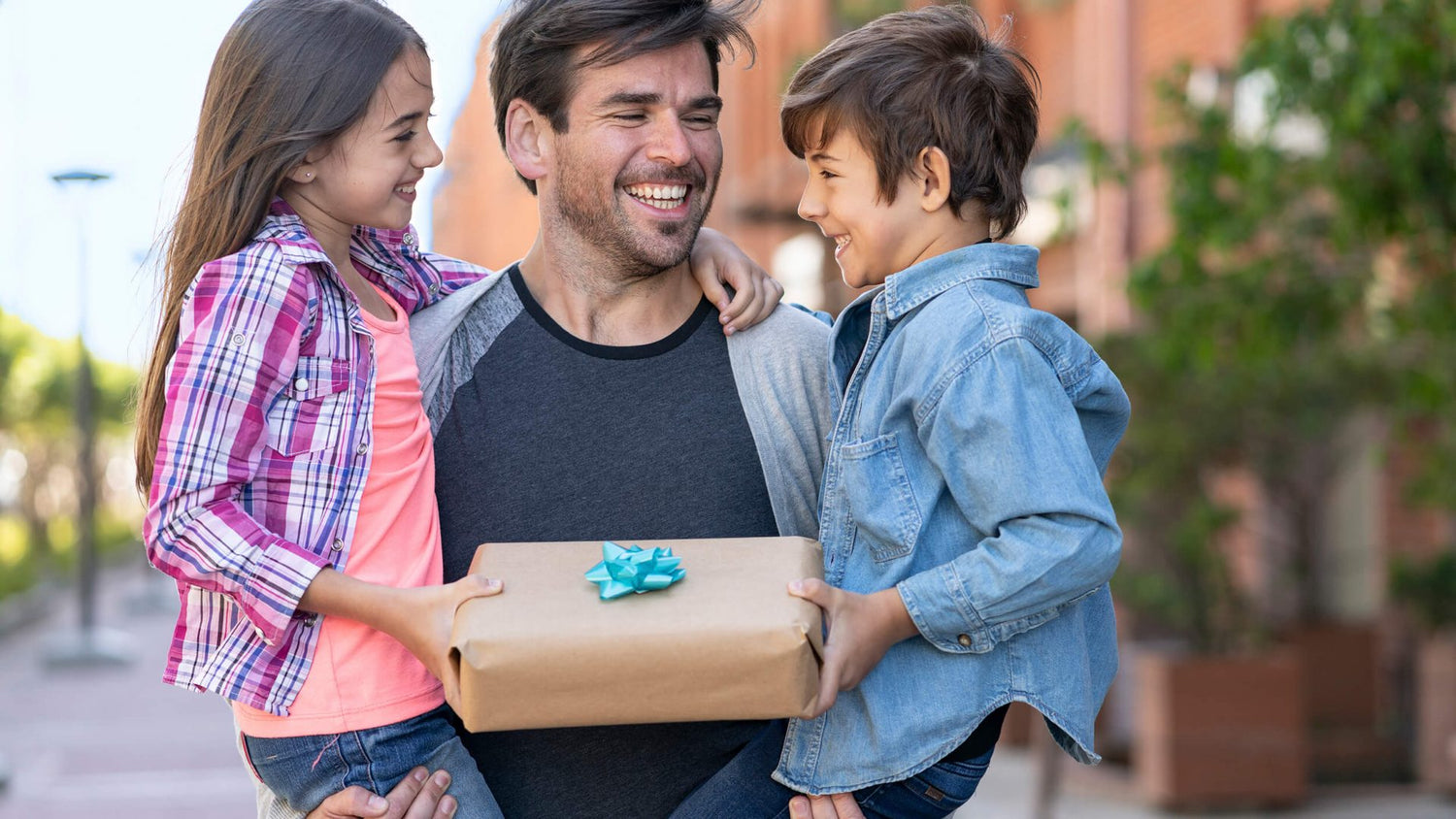 children giving gift to their father on fathers day by flower bouquet