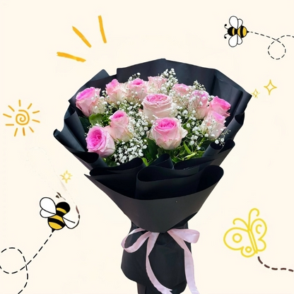 A bouquet of premium pink bi-color roses and white baby's breath wrapped in elegant black matte paper tied with a pink ribbon.