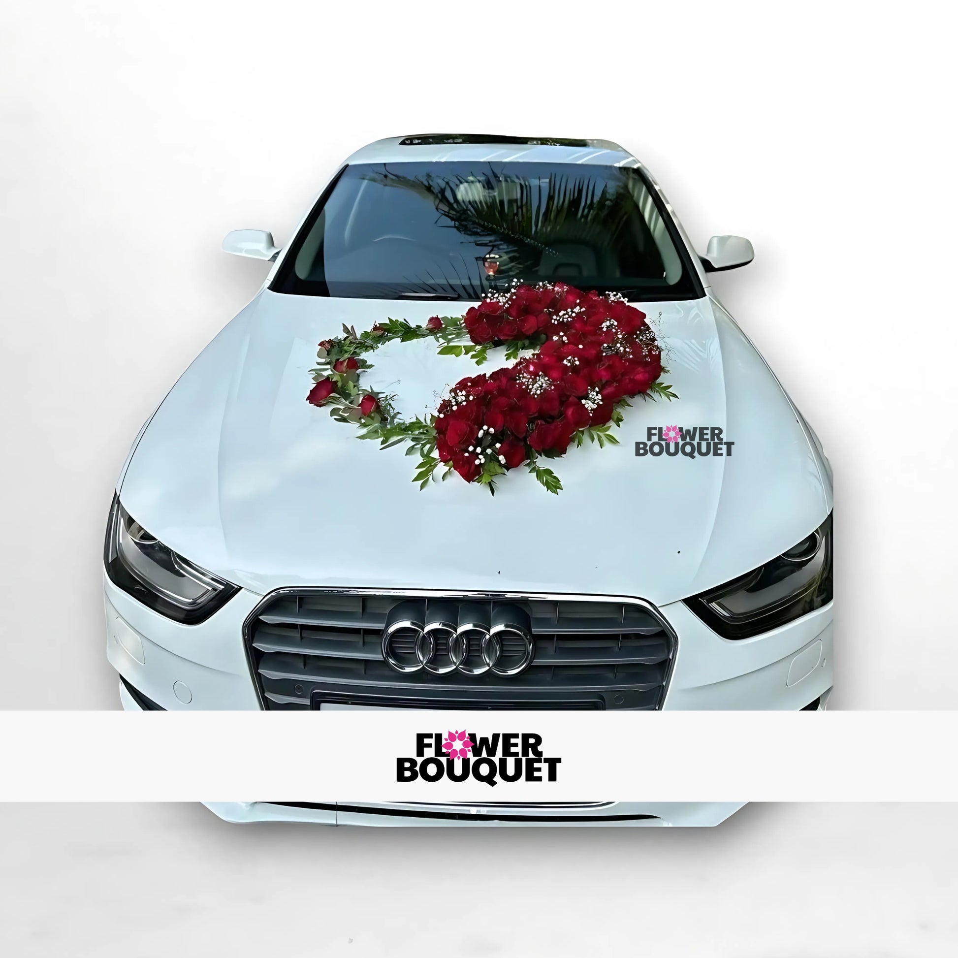 White Audi decorated with heart-shaped red rose arrangement on hood for weddings, Flower Bouquet logo visible.