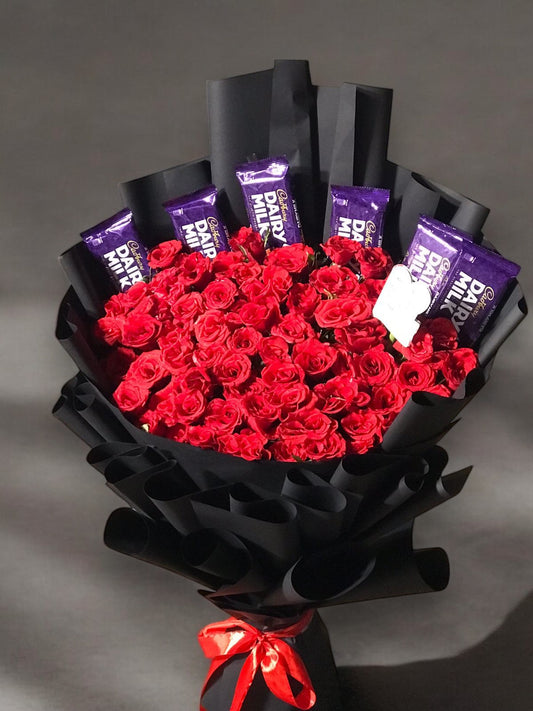 vibrant red roses interspersed with Dairy Milk chocolate bars.