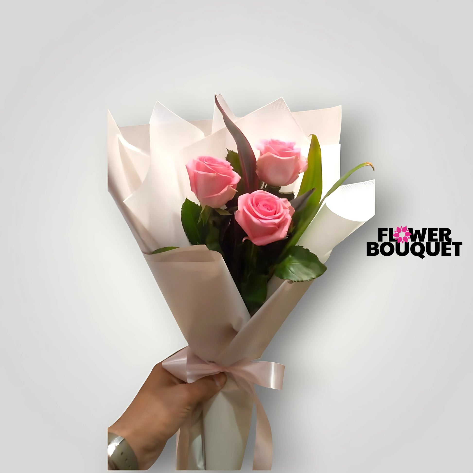 Elegant bouquet of soft pink roses wrapped in delicate paper, showcasing a romantic and feminine floral arrangement.