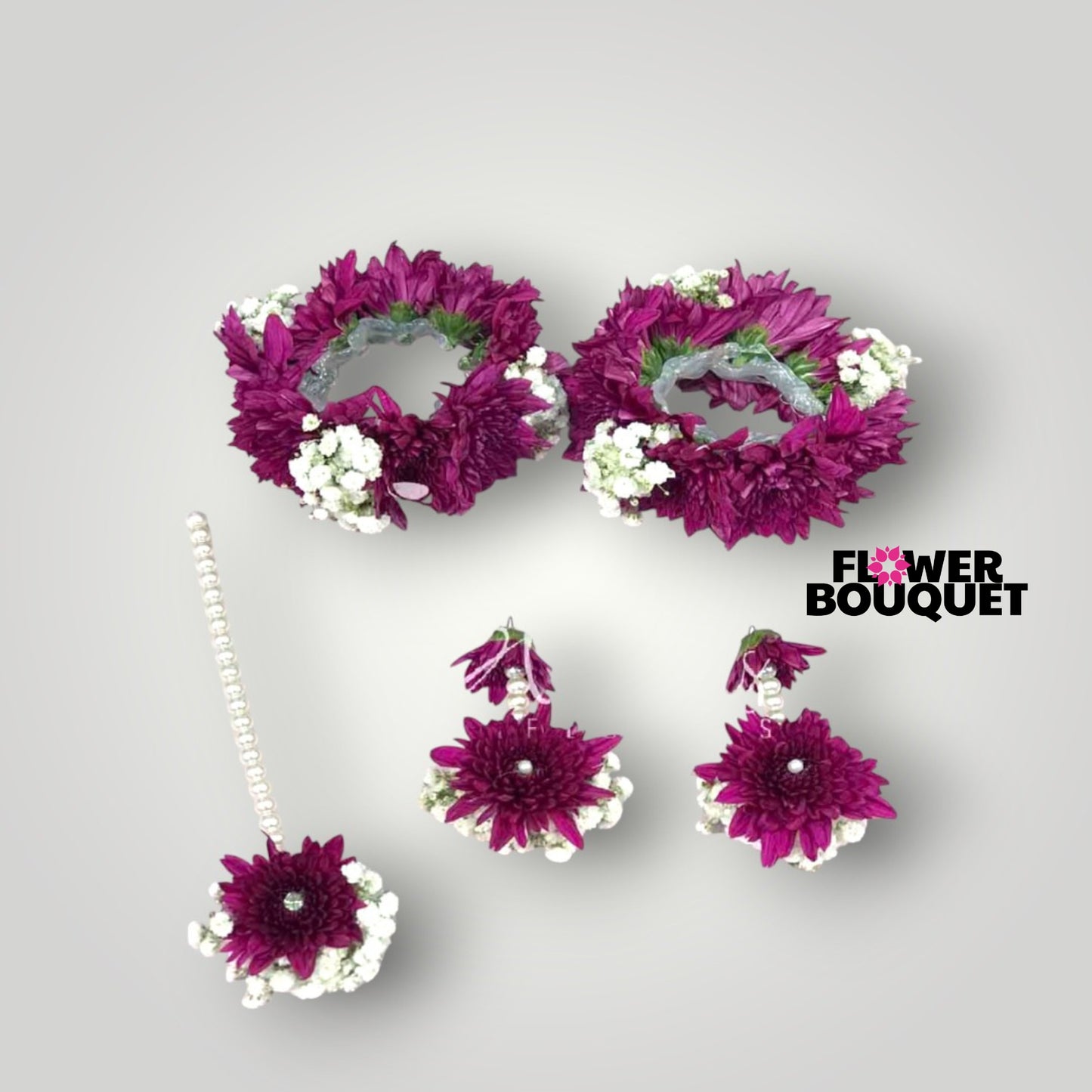 Elegant floral jewelry set with wrist corsages, hair accessory, and earrings featuring vibrant purple flowers and white blossoms.