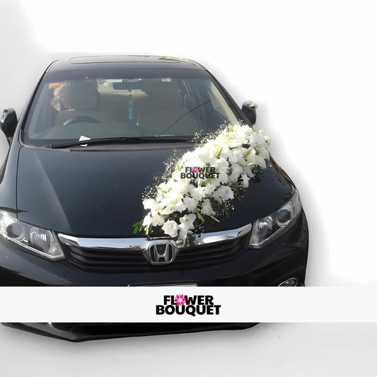 Black Honda City decorated with white floral arrangement on hood for weddings, Flower Bouquet logo visible.