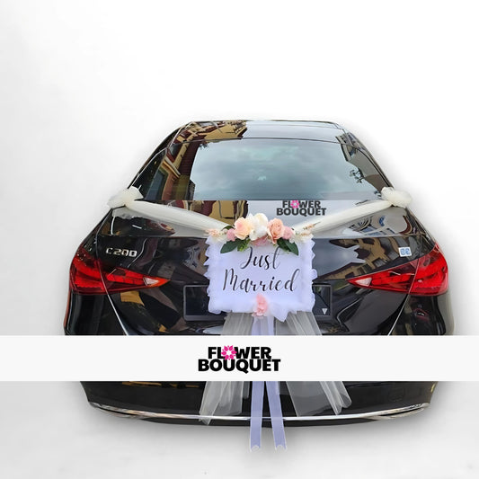 Black Mercedes C200 decorated with "Just Married" sign, flowers, and white tulle for weddings, Flower Bouquet logo visible.