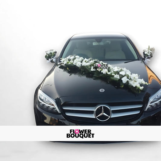 Black Mercedes decorated with white floral garland on hood and mirror bouquets for wedding.