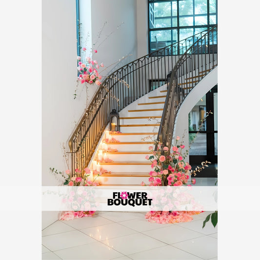 A stunning floral display adorning a grand staircase, with lush pink roses and greenery cascading down the steps, creating a magical and romantic ambiance.