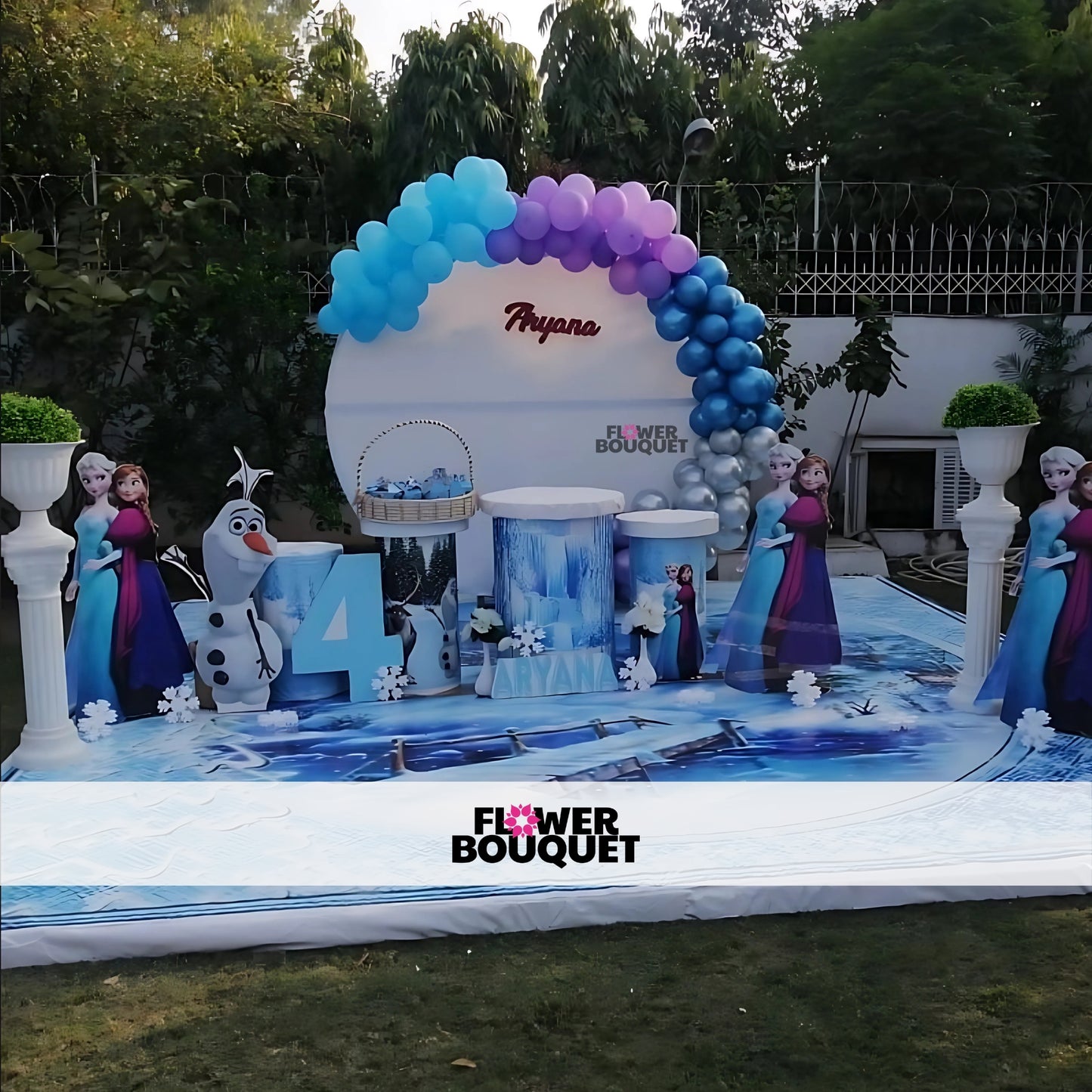 Decorated outdoor setup for a birthday party with a "Frozen" theme.