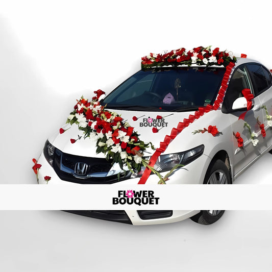 Car decorated with red and white flowers, ribbon, and Flower Bouquet logo for wedding.