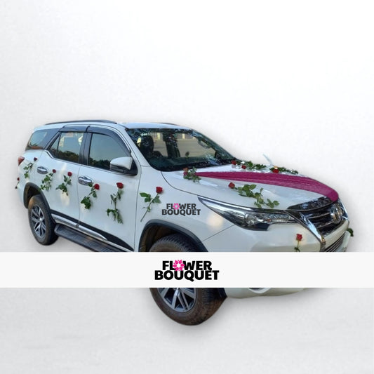 White Toyota Fortuner decorated with red roses, fuchsia fabric, and green vines for weddings, Flower Bouquet logo visible.