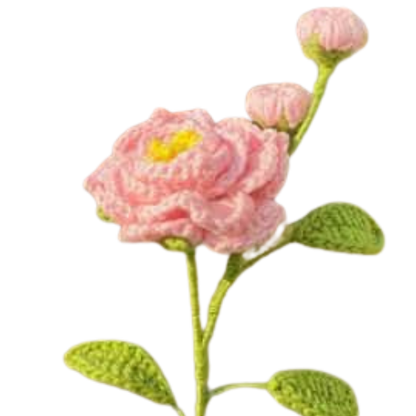 Handmade crochet camellia flower with two pink buds and green leaves on a long stem.
