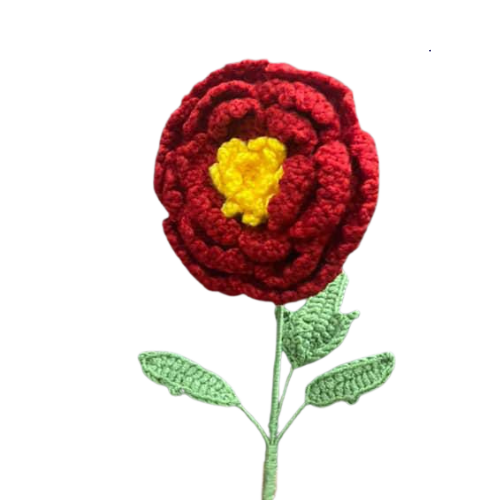 Handmade crochet marigold-inspired flower with red petals, yellow center, and green leaves.