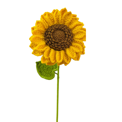 Handmade crochet sunflower with yellow petals, brown center, and green leaf on a stem.