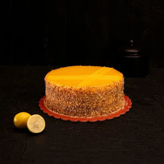 "Jlal Sons Classic Lemon Cake with lemon cream topping and nut coating, available in Lahore, Karachi, and Islamabad"