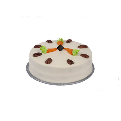 "Kitchen Cuisine Carrot Cake with cream cheese frosting, walnuts, and carrot decorations, available in Lahore, Karachi, and Islamabad"