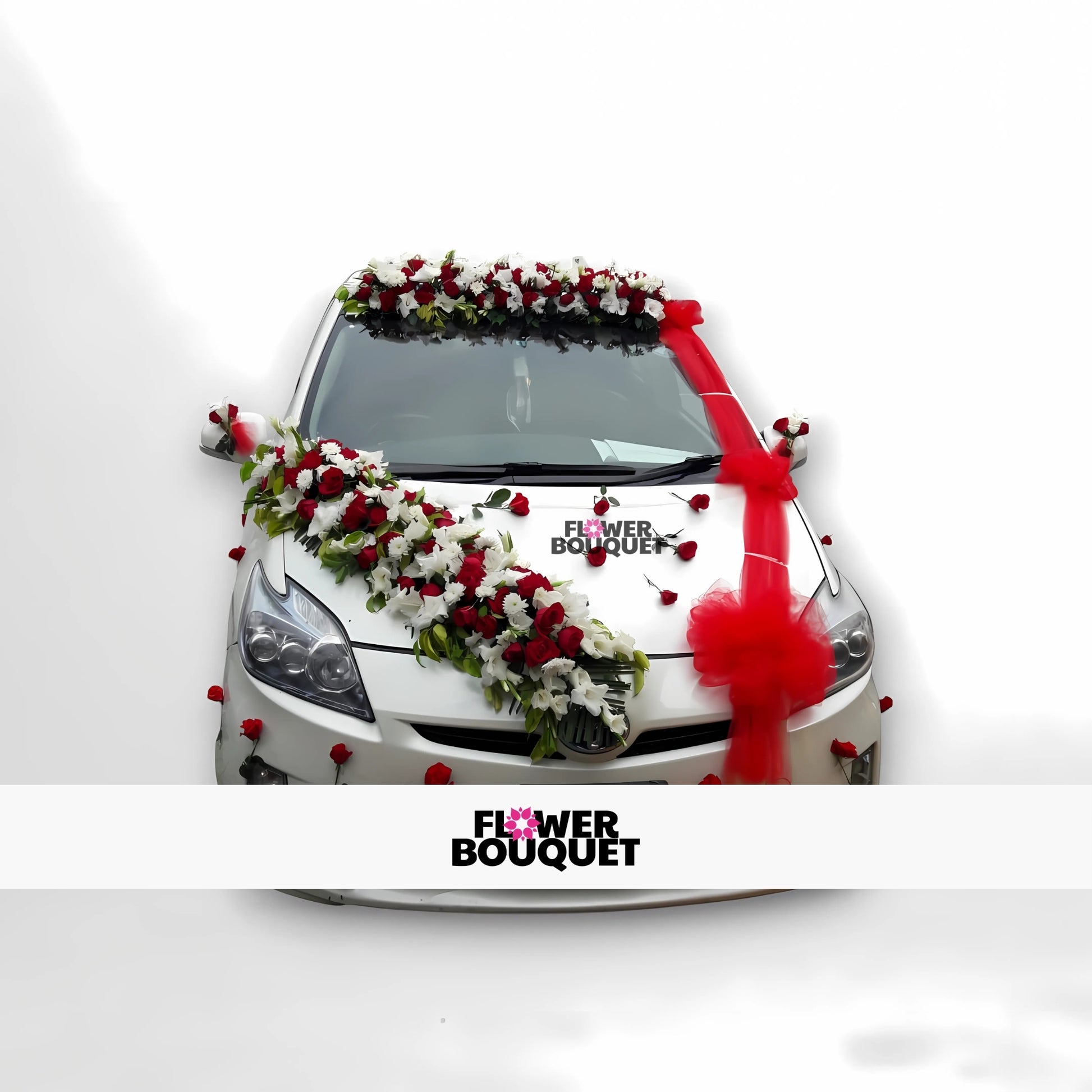 White car decorated with red and white flowers and a red ribbon.