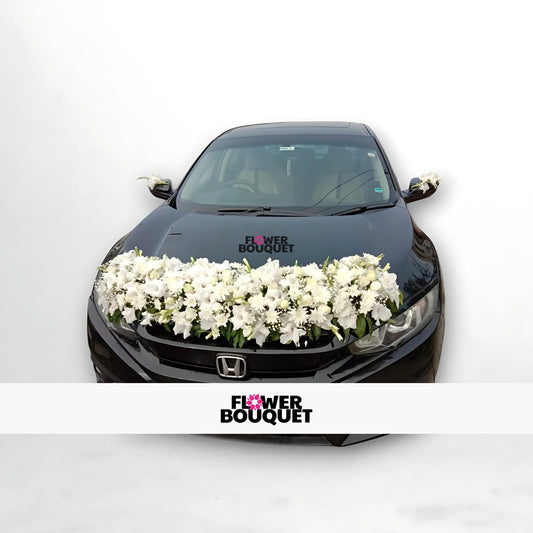 Black Honda car decorated with white flowers on the hood and side mirrors.