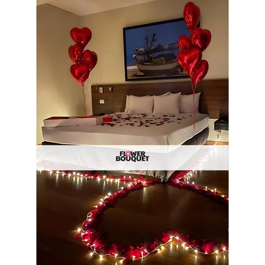 Romantic bedroom setup with red rose petals, heart-shaped balloons on headboard, and fairy lights creating a loving atmosphere.