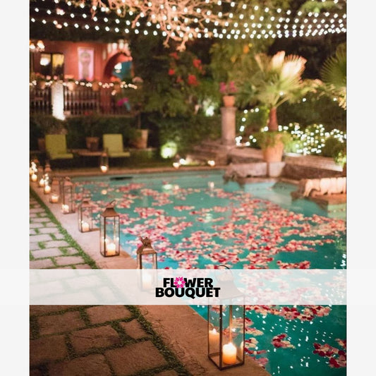  A serene and enchanting nighttime scene featuring a lush, flower-filled pool surrounded by a cozy, historic-style building adorned with twinkling lights, creating a magical and romantic ambiance.