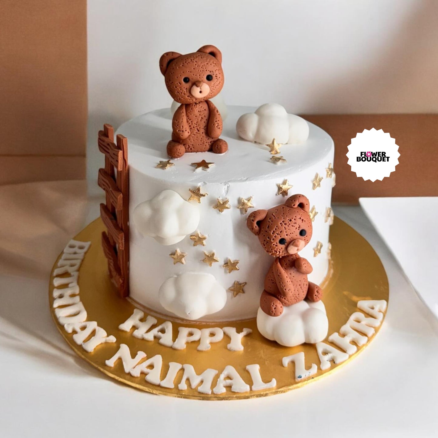 Cute cake with two brown teddy bears, fluffy clouds, shiny stars, and a tiny ladder on white frosting.