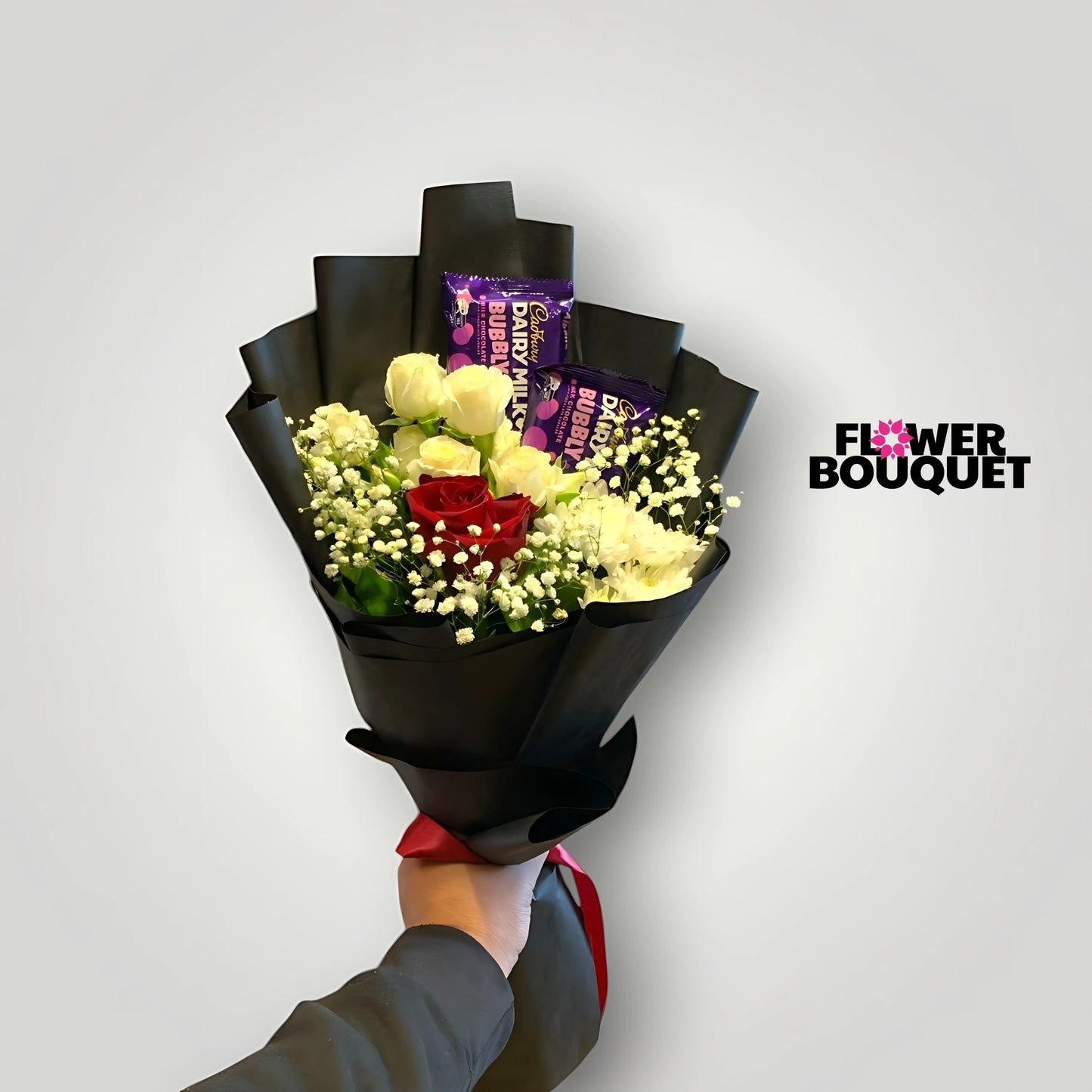 A vibrant bouquet of yellow and red roses with baby's breath, wrapped in a sleek black paper, creating a modern and sophisticated floral arrangement.