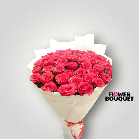 Lush, vibrant pink roses arranged in a beautiful bouquet, presented in a simple yet sophisticated wrapping.