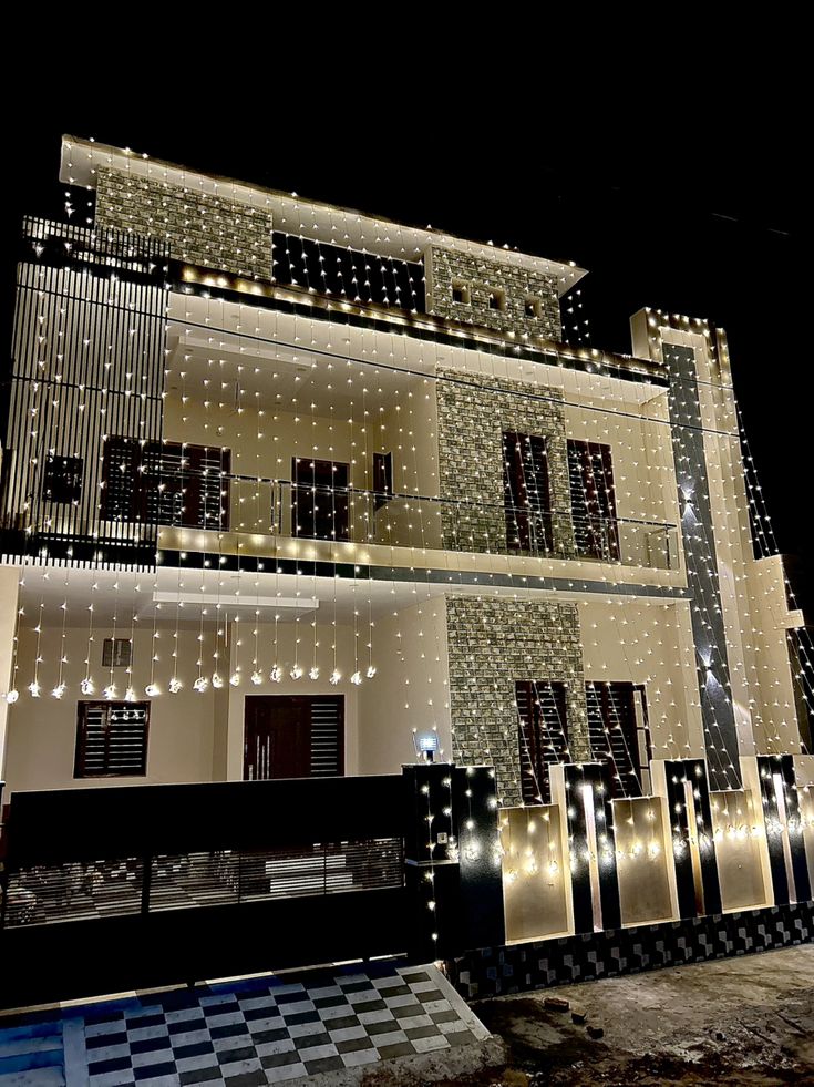 Wedding house outdoor lights beautifully lighting up a home exterior, perfect for an elegant celebration.