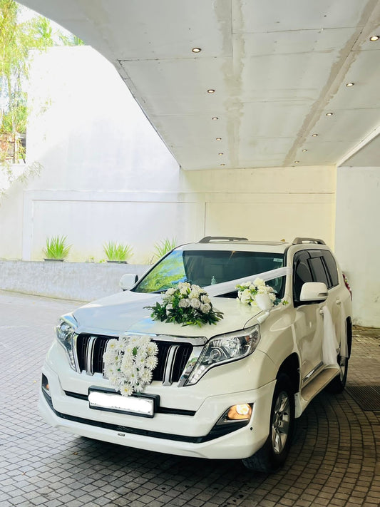 white Land Cruiser Prado Decoration in Lahore with imported red and white roses